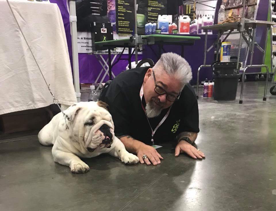 man on floor with bulldog